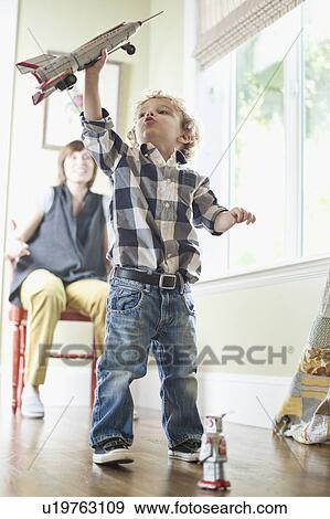 Stock Photo - USA, Utah, Boy (2-3) playing on floor. Fotosearch