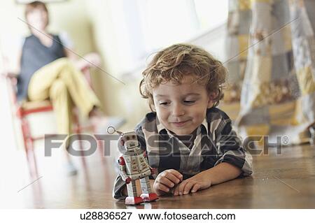 Stock Photo - USA, Utah, Boy (2-3) playing on floor. Fotosearch