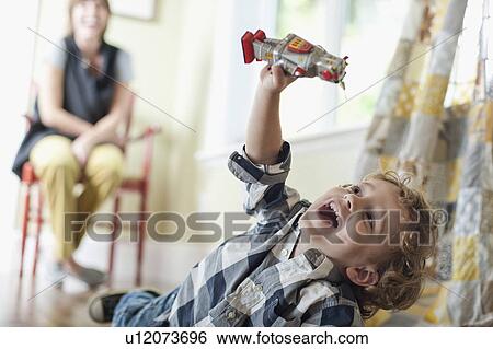 Stock Photograph - USA, Utah, Boy (2-3) playing on floor. Fotosearch