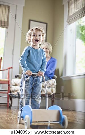 Stock Image - USA, Utah, Boy (2-3) playing with toy cart. Fotosearch
