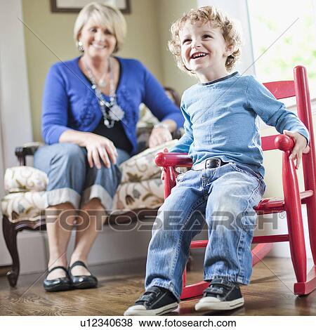 Stock Photo - USA, Utah, Boy (2-3) playing with toy cart. Fotosearch