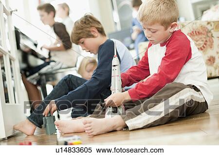 USA, Utah, Boys (6-7, 8-9) playing on floor View Large Photo Image Stock Photography - USA, Utah, Boys (6-7, 8-9) playing on floor. Fotosearch