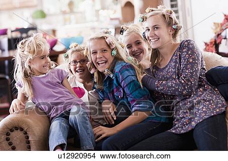Picture - USA, Utah, family portrait of sisters (6-7, 8-9, 12-13, 14-15, 16-17) on sofa having fun. Fotosearch