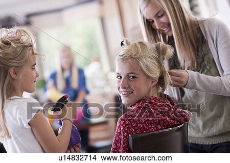 Picture - USA, Utah, family portrait of sisters (6-7, 8-9, 12-13, 14-15, 16-17) preparing hairs and having fun. Fotosearch