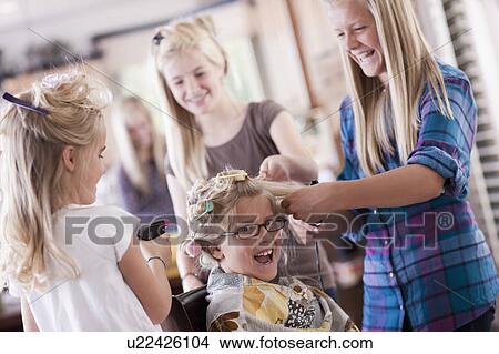 Picture - USA, Utah, family portrait of sisters (6-7, 8-9, 12-13, 14-15, 16-17) preparing hairs and having fun. Fotosearch