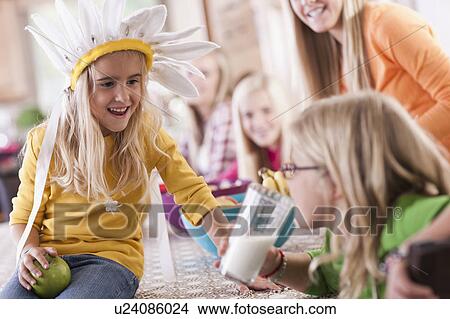 Picture - USA, Utah, family portrait of sisters (6-7, 8-9, 12-13, 14-15, 16-17)having fun at table. Fotosearch