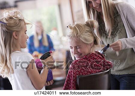 Stock Image - USA, Utah, family portrait of sisters (6-7, 8-9, 12-13, 14-15, 16-17) preparing hairs and having fun. Fotosearch