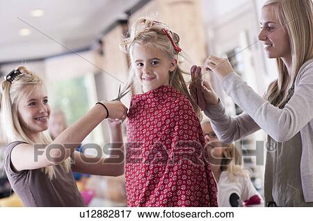 Stock Photo - USA, Utah, family portrait of sisters (6-7, 8-9, 12-13, 14-15, 16-17) preparing hairs and having fun. Fotosearch