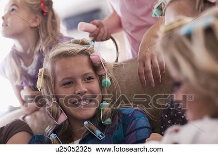 Stock Photography - USA, Utah, family portrait of sisters (6-7, 8-9, 12-13, 14-15, 16-17) preparing hairs and having fun. Fotosearch