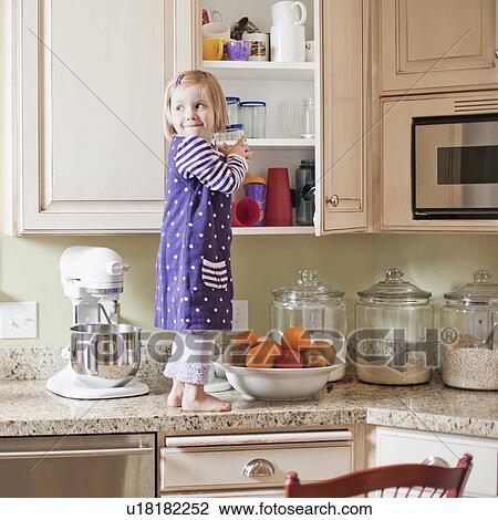 USA, Utah, Girl (2-3) climbing on cupboard in kitchen View Large Photo Image Stock Image - USA, Utah, Girl (2-3) climbing on cupboard in kitchen. Fotosearch