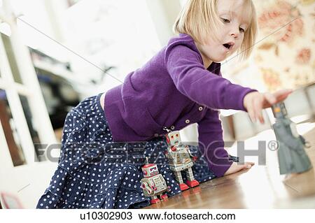 Stock Image - USA, Utah, Girl (2-3) playing on floor. Fotosearch