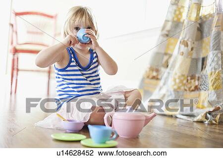 Stock Image - USA, Utah, Girl (2-3) playing on floor. Fotosearch