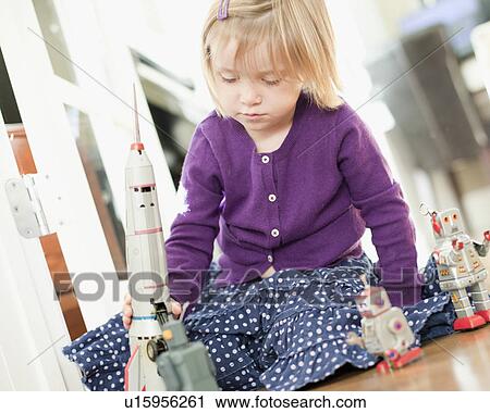 Stock Image - USA, Utah, Girl (2-3) playing on floor. Fotosearch