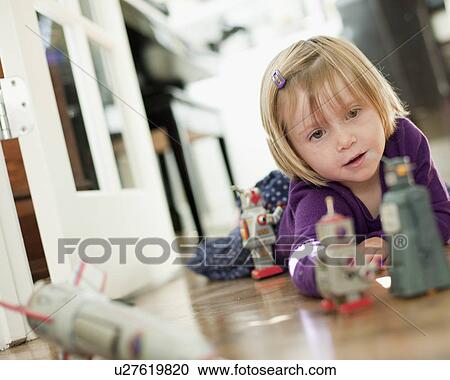 Stock Image - USA, Utah, Girl (2-3) playing on floor. Fotosearch