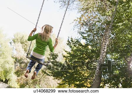 USA, Utah, girl (6-7) swinging on tree swing View Large Photo Image Stock Photo - USA, Utah, girl (6-7) swinging on tree swing. Fotosearch