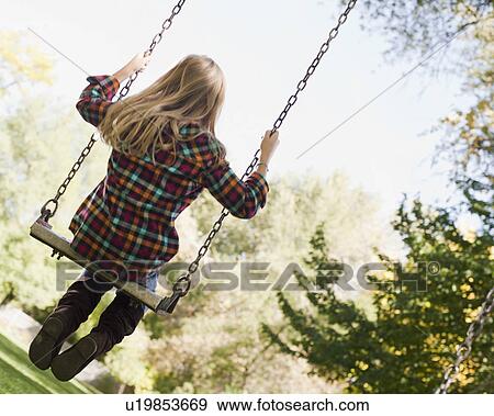 USA, Utah, girl (6-7) swinging on tree swing View Large Photo Image Stock Photo - USA, Utah, girl (6-7) swinging on tree swing. Fotosearch