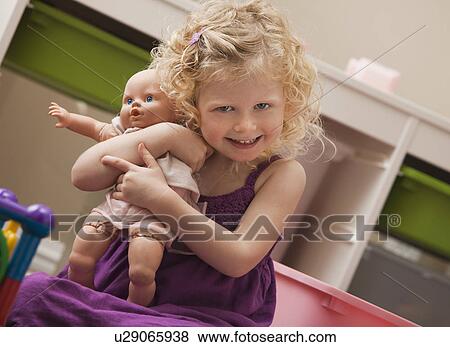 Stock Photo - USA, Utah, Lehi, girl (2-3) hugging doll. Fotosearch