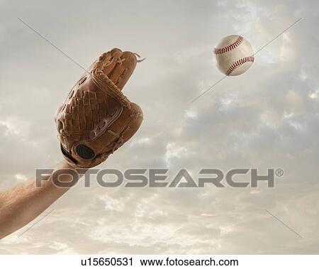 Stock Image - USA, Utah, Lehi, hand of baseball player catching baseball. Fotosearch