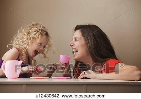 Stock Image - USA, Utah, Lehi, mother and daughter (2-30 having tea. Fotosearch