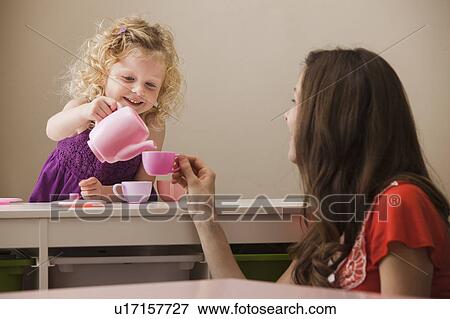 Stock Photo - USA, Utah, Lehi, mother and daughter (2-30 having tea. Fotosearch