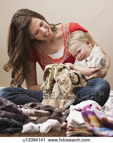 USA, Utah, Lehi, mother and son (18-23 months) folding laundry View Large Photo Image Stock Image - USA, Utah, Lehi, mother and son (18-23 months) folding laundry. Fotosearch