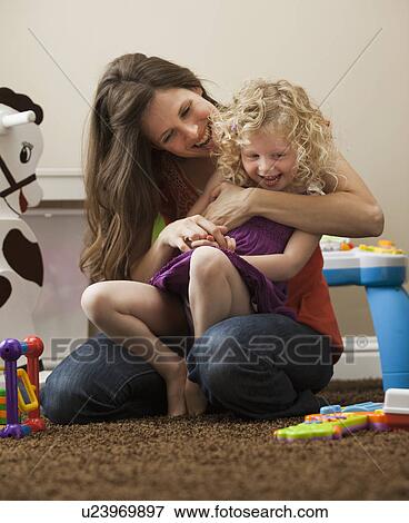 Stock Photo - USA, Utah, Lehi, mother embracing daughter (2-3). Fotosearch