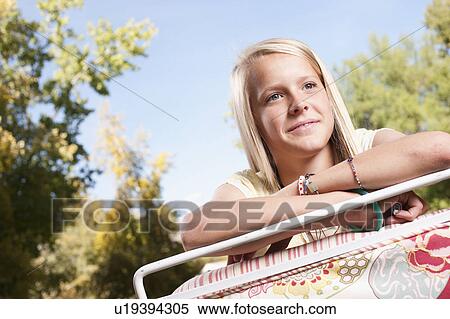 USA, Utah, outdoor of blonde girl (12-13)leaning on deck chair View Large Photo Image Stock Photography - USA, Utah, outdoor of blonde girl (12-13)leaning on deck chair. Fotosearch