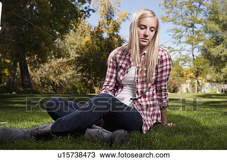 USA, Utah, outdoor portrait of blonde teenage girl (14-15) sitting on grass View Large Photo Image Stock Image - USA, Utah, outdoor portrait of blonde teenage girl (14-15) sitting on grass. Fotosearch