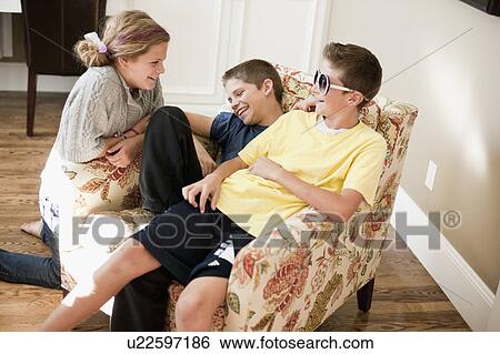 Stock Photograph - USA, Utah, Portrait of kids (2-3, 6-7, 10-11, 10-11) playing in living room. Fotosearch