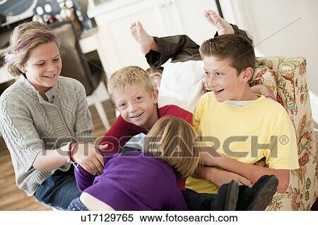 Stock Photography - USA, Utah, Portrait of kids (2-3, 6-7, 10-11, 10-11) playing in living room. Fotosearch