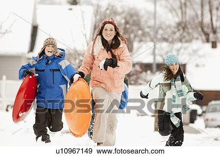 USA, Utah, Provo, Boys (10-11, 12-13) and girls (10-11, 16-17) running with sledge View Large Photo Image Stock Photo - USA, Utah, Provo, Boys (10-11, 12-13) and girls (10-11, 16-17) running with sledge. Fotosearch