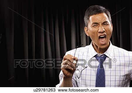 USA, Utah, Provo, Portrait of businessman standing in front of black curtain View Large Photo Image Stock Image - USA, Utah, Provo, Portrait of businessman standing in front of black curtain. Fotosearch