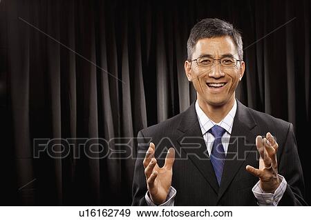 USA, Utah, Provo, Portrait of businessman having speech in front of black curtain View Large Photo Image Stock Photo - USA, Utah, Provo, Portrait of businessman having speech in front of black curtain. Fotosearch
