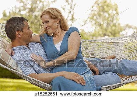 USA, Utah, Provo, Smiling mature couple relaxing in hammock in garden View Large Photo Image Stock Image - USA, Utah, Provo, Smiling mature couple relaxing in hammock in garden. Fotosearch