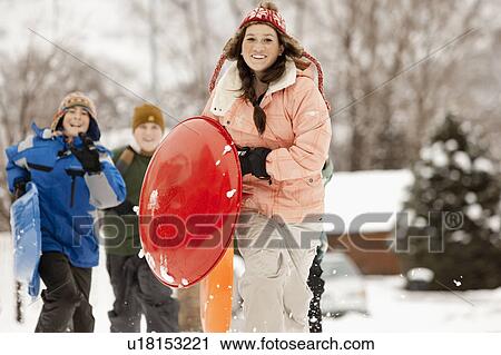 USA, Utah, Provo, Teenage (16-17) girl running with sledge, boys and girls (10-11, 12-13) in background View Large Photo Image Stock Image - USA, Utah, Provo, Teenage (16-17) girl running with sledge, boys and girls (10-11, 12-13) in background. Fotosearch