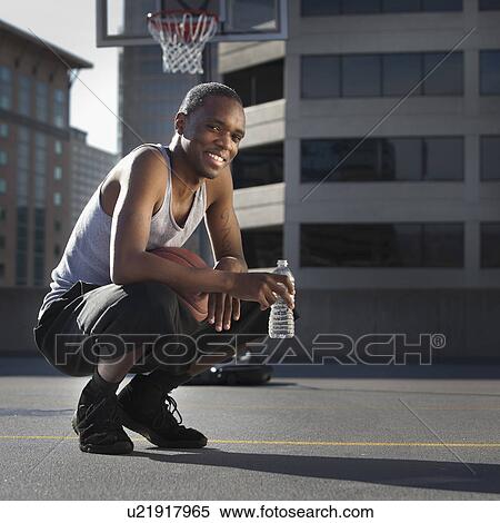 USA, Utah, Salt Lake City, basketball player holding water bottle View Large Photo Image Stock Photography - USA, Utah, Salt Lake City, basketball player holding water bottle. Fotosearch