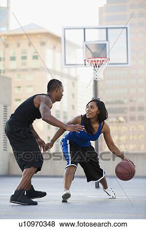 USA, Utah, Salt Lake City, young man and young woman playing basketball View Large Photo Image Stock Photo - USA, Utah, Salt Lake City, young man and young woman playing basketball. Fotosearch