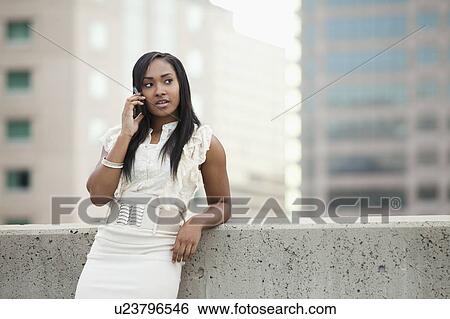 USA, Utah, Salt Lake City, Young businesswoman talking on mobile phone View Large Photo Image Stock Photograph - USA, Utah, Salt Lake City, Young businesswoman talking on mobile phone. Fotosearch