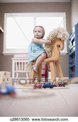 Stock Photography - USA, Utah, small girl (2-3) on rocking horse. Fotosearch