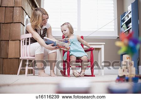 USA, Utah, small girl (2-3) with nanny reading book View Large Photo Image Stock Photo - USA, Utah, small girl (2-3) with nanny reading book. Fotosearch