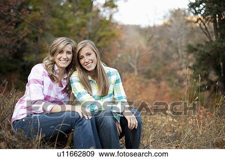 USA, Utah, Sundance, Portrait of two young women sitting on meadow View Large Photo Image Stock Photo - USA, Utah, Sundance, Portrait of two young women sitting on meadow. Fotosearch