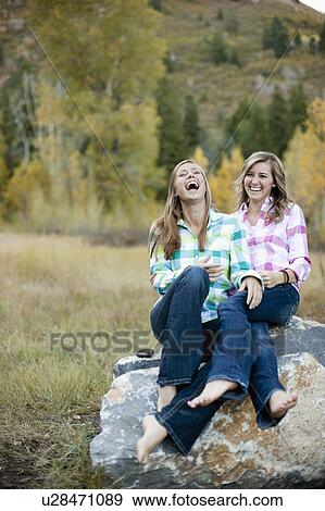 USA, Utah, Sundance, Two young women sitting on boulder and laughing View Large Photo Image Stock Photo - USA, Utah, Sundance, Two young women sitting on boulder and laughing. Fotosearch