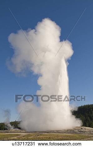 Stock Image - USA, Wyoming, Old Faithful geyser steam. Fotosearch