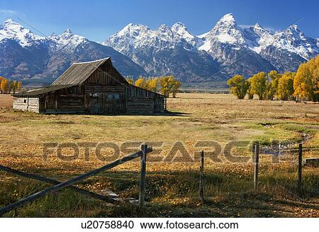 Stock Image - USA, Wyoming, Teton Range and barn. Fotosearch