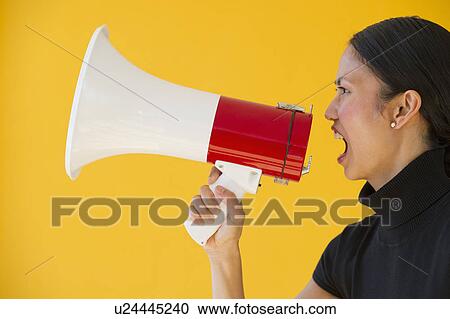 Woman shouting through megaphone View Large Photo Image Stock Image - Woman shouting through megaphone. Fotosearch