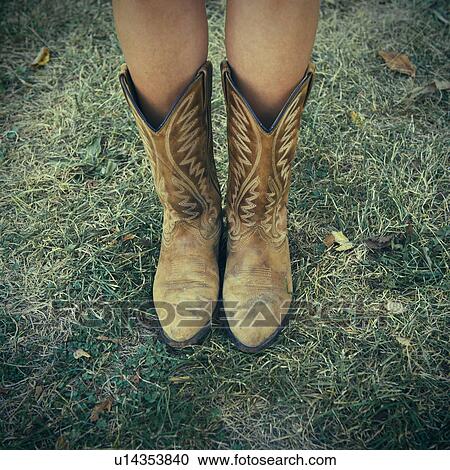 Woman wearing cowboy boots on lawn View Large Photo Image Stock Image - Woman wearing cowboy boots on lawn. Fotosearch
