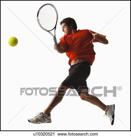 Stock Image - Young man playing tennis. Fotosearch