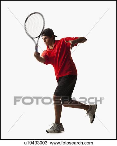 Stock Image - Young man playing tennis. Fotosearch