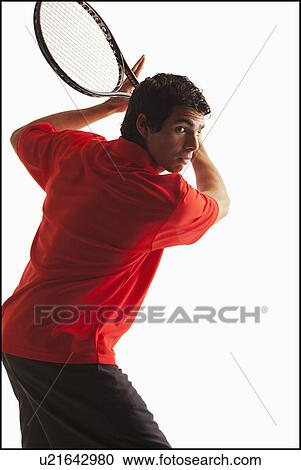 Stock Image - Young man playing tennis. Fotosearch