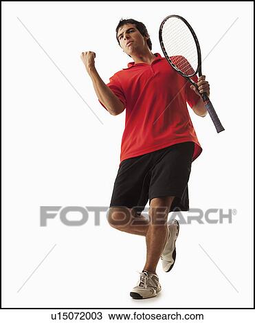 Stock Image - Young man playing tennis winning. Fotosearch